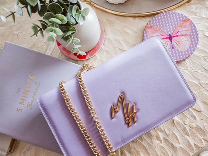 Mel Style lavender leather bag styled with journal and butterfly coaster