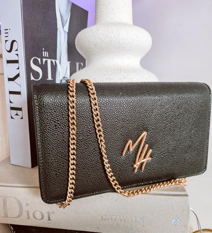 Mel Style black leather bag styled with fashion books and gold chain